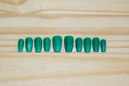 Wintergreen cat eye press on nails with matte finish featured on a wooden background