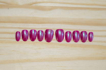 Berry pink press-on nails with a subtle light blue chrome overlay on a pink card