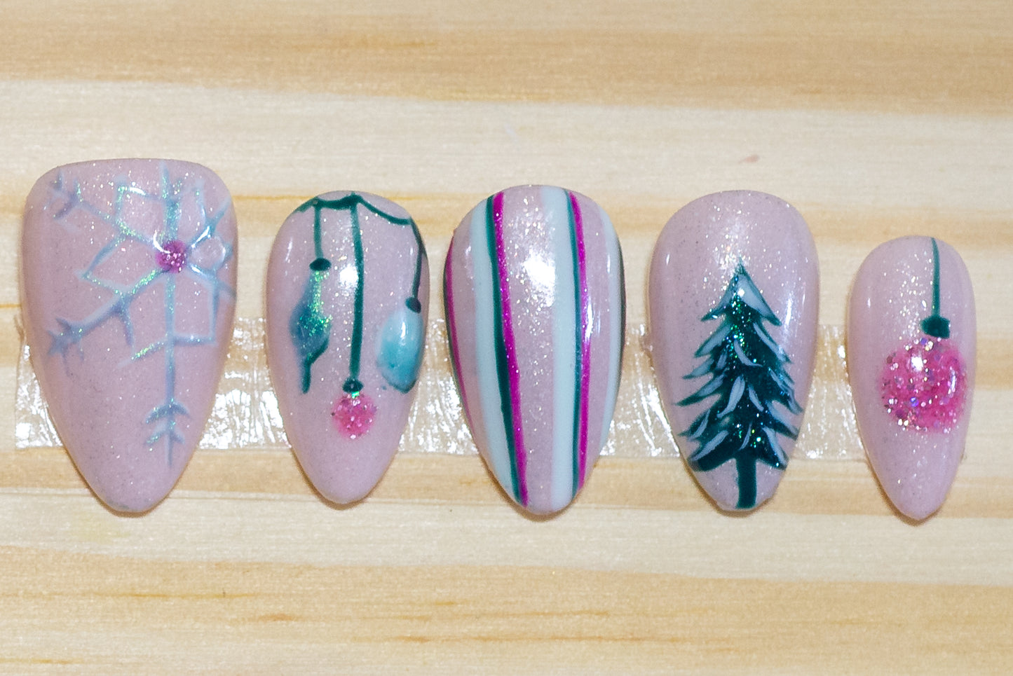 Christmas holiday press on nails with mid-century pastel theme on a wooden background